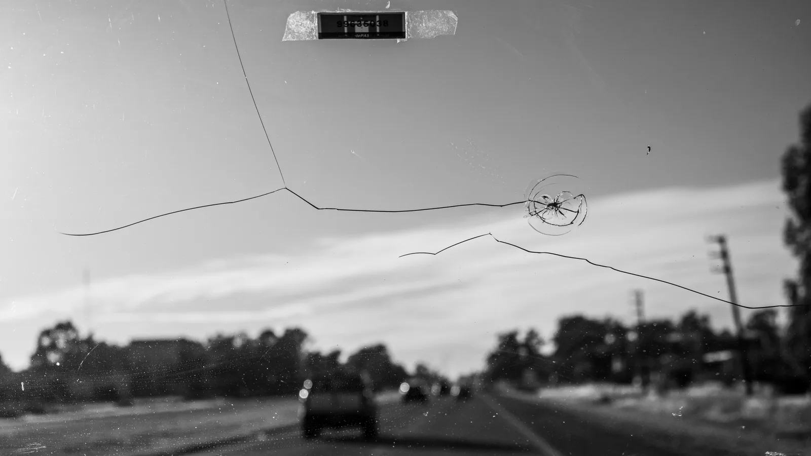 A crack spreading across a windscreen, seen from the driver seat