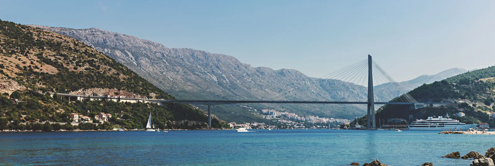 A cable-stayed road bridge crossing a bay on the Croatian coast